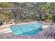 Screened in pool area featuring brick coping and tropical landscaping at 5234 Ohio St, Winter Park, FL 32792