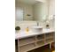 Well-lit bathroom featuring a round vessel sink, open storage vanity, and large mirror at 5245 W Irlo Bronson Memorial Hwy # 148, Kissimmee, FL 34746