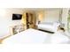 Cozy bedroom with two beds, a workspace, closet, and a modern TV at 5245 W Irlo Bronson Memorial Hwy # 148, Kissimmee, FL 34746