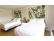 Bright bedroom featuring two beds, modern artwork, and minimalist decor at 5245 W Irlo Bronson Memorial Hwy # 148, Kissimmee, FL 34746