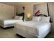 Modern bedroom with two beds and artistic decor creates a cozy ambiance at 5245 W Irlo Bronson Memorial Hwy # 148, Kissimmee, FL 34746