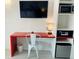 Bright bedroom featuring a desk, a television, and a microwave at 5245 W Irlo Bronson Memorial Hwy # 148, Kissimmee, FL 34746
