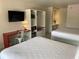 Modern bedroom with two beds, a built-in desk, closet, and a TV at 5245 W Irlo Bronson Memorial Hwy # 148, Kissimmee, FL 34746