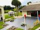 Outdoor community area with tables, seating, and a playground area including Connect Four at 5245 W Irlo Bronson Memorial Hwy # 148, Kissimmee, FL 34746