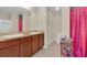 Bathroom with double sink vanity, large mirror, tile flooring, and modern fixtures at 561 Lake Cummings Way, Lake Alfred, FL 33850