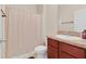 Bathroom features a shower with curtain, toilet, and vanity with sink and countertop at 561 Lake Cummings Way, Lake Alfred, FL 33850
