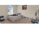 Bedroom features a bed, window, and personal items with a view of the outdoors at 561 Lake Cummings Way, Lake Alfred, FL 33850