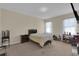 Comfortable bedroom with plush carpet, natural light, and a cozy atmosphere at 561 Lake Cummings Way, Lake Alfred, FL 33850