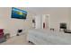 Well-lit bedroom with plush carpeting, neutral paint, and television at 561 Lake Cummings Way, Lake Alfred, FL 33850