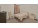 Cozy bedroom features neutral tones, a comfortable bed, and window coverings for a relaxing atmosphere at 561 Lake Cummings Way, Lake Alfred, FL 33850