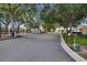 Gated community entrance with mature trees, enhancing privacy and security at 561 Lake Cummings Way, Lake Alfred, FL 33850