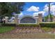 Elegant stone community sign with lush landscaping, showcasing the neighborhood's charm at 561 Lake Cummings Way, Lake Alfred, FL 33850