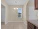 Bright dining area featuring tile floors and an elegant chandelier at 561 Lake Cummings Way, Lake Alfred, FL 33850
