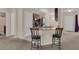 Open-concept kitchen with breakfast bar, double sink, stainless steel appliances, and pendant lighting at 561 Lake Cummings Way, Lake Alfred, FL 33850