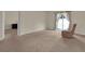 Spacious living room with plush carpeting and a neutral color scheme at 561 Lake Cummings Way, Lake Alfred, FL 33850