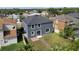 Aerial view of a house with a gray exterior and a backyard featuring a stone pathway at 5768 Los Palma Vista Dr, Orlando, FL 32837