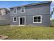Exterior elevation of the house showcases a well-maintained yard with a patio, offering a perfect space for outdoor enjoyment at 5768 Los Palma Vista Dr, Orlando, FL 32837
