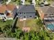 An aerial view of the backyard featuring a well-maintained lawn and two brick patio areas at 5768 Los Palma Vista Dr, Orlando, FL 32837