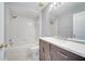 Well-lit bathroom features a tub-shower combo, neutral-toned vanity and ample lighting at 5768 Los Palma Vista Dr, Orlando, FL 32837