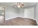 Spacious bedroom featuring wood-look floors, a ceiling fan, and a closet for ample storage at 5768 Los Palma Vista Dr, Orlando, FL 32837
