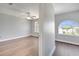 Upstairs bedroom with wood floors, ample natural light, and neutral wall color at 5768 Los Palma Vista Dr, Orlando, FL 32837