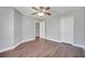 Neutral bedroom with modern flooring, fan and a double closet at 5768 Los Palma Vista Dr, Orlando, FL 32837