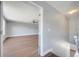 View into a bedroom from the hallway, featuring wood floors, ceiling fan and natural light at 5768 Los Palma Vista Dr, Orlando, FL 32837