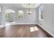 Elegant dining room with an archway, wood floors, bright windows, and chandelier lighting at 5768 Los Palma Vista Dr, Orlando, FL 32837