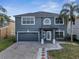 Charming two-story home featuring a brick driveway and lush landscaping at 5768 Los Palma Vista Dr, Orlando, FL 32837