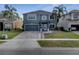Charming two-story home featuring a brick driveway and lush landscaping at 5768 Los Palma Vista Dr, Orlando, FL 32837