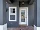 Covered entryway with decorative front door and updated lighting at 5768 Los Palma Vista Dr, Orlando, FL 32837