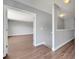 Hallway area that leads to a room with brown floors and light grey walls throughout the area at 5768 Los Palma Vista Dr, Orlando, FL 32837
