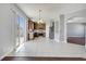 Bright kitchen with stainless appliances, a kitchen island, white tile floors, and sliding glass doors to the patio at 5768 Los Palma Vista Dr, Orlando, FL 32837
