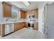 Updated kitchen with stainless steel appliances, mosaic backsplash, tile floor, and wood cabinets at 5768 Los Palma Vista Dr, Orlando, FL 32837