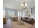 Open-concept living room featuring a dining area, stylish chandelier, and comfortable sofa at 5768 Los Palma Vista Dr, Orlando, FL 32837