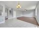 Open-concept living room with tile and wood floors, a modern chandelier, and views to the stairway at 5768 Los Palma Vista Dr, Orlando, FL 32837