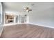 Large living room opens to the kitchen with wood floors and modern lighting at 5768 Los Palma Vista Dr, Orlando, FL 32837