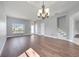 Spacious living area with wood floors, a chandelier, large windows, and a staircase at 5768 Los Palma Vista Dr, Orlando, FL 32837
