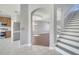 Open floor plan showcasing kitchen, living room, and staircase with archway and modern finishes at 5768 Los Palma Vista Dr, Orlando, FL 32837