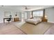 Staged main bedroom with neutral tones, a large window, and a comfortable, stylish feel at 5768 Los Palma Vista Dr, Orlando, FL 32837