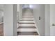 Stairway with wooden treads and white risers leads to the upper level of the home at 5768 Los Palma Vista Dr, Orlando, FL 32837