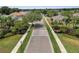 A landscaped street view of the community with palm trees and well-maintained lawns at 5768 Los Palma Vista Dr, Orlando, FL 32837