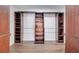 Spacious walk-in closet with custom wood shelving and ample storage space for an organized wardrobe at 5768 Los Palma Vista Dr, Orlando, FL 32837