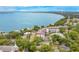 Scenic aerial view showcasing a lakeside building and lush trees at 606 N Mcdonald St, Mount Dora, FL 32757