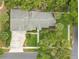 Aerial view of the home showcasing its landscaped yard, private driveway, and serene neighborhood setting at 606 N Mcdonald St, Mount Dora, FL 32757
