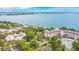 Breathtaking aerial view capturing a lake, trees, and a lakeside residential building at 606 N Mcdonald St, Mount Dora, FL 32757