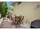 A back patio with brick pavers showcases seating for four, ideal for relaxing or entertaining guests outdoors at 606 N Mcdonald St, Mount Dora, FL 32757