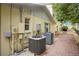 A shady backyard patio features brick pavers and includes dual air conditioning units and outdoor seating at 606 N Mcdonald St, Mount Dora, FL 32757
