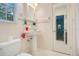 Bathroom featuring pedestal sink, commode, and tiled floor with complementary wall tile detail at 606 N Mcdonald St, Mount Dora, FL 32757