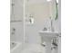 Bathroom featuring white tiles, a pedestal sink, shower with curtain, and window at 606 N Mcdonald St, Mount Dora, FL 32757